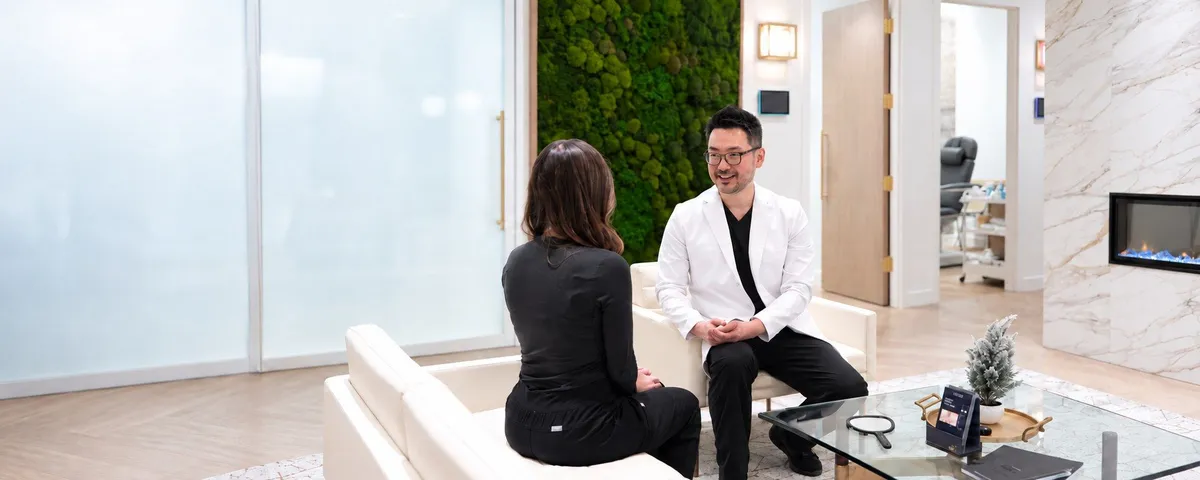 Dr. Danny Guo in a biostimulator consultation with a patient in Calgary