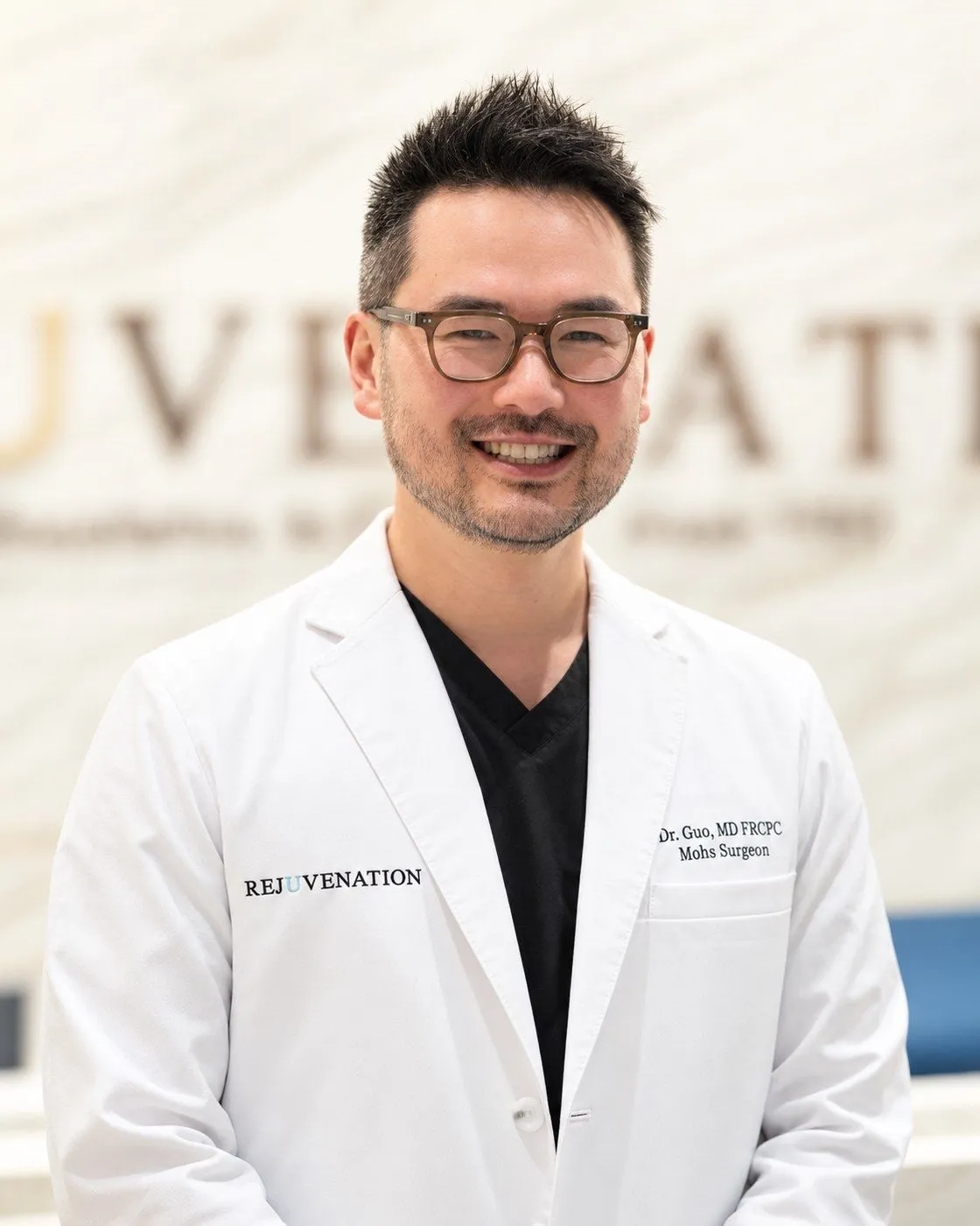 Dr. Danny Guo, dermatologist, in a white coat