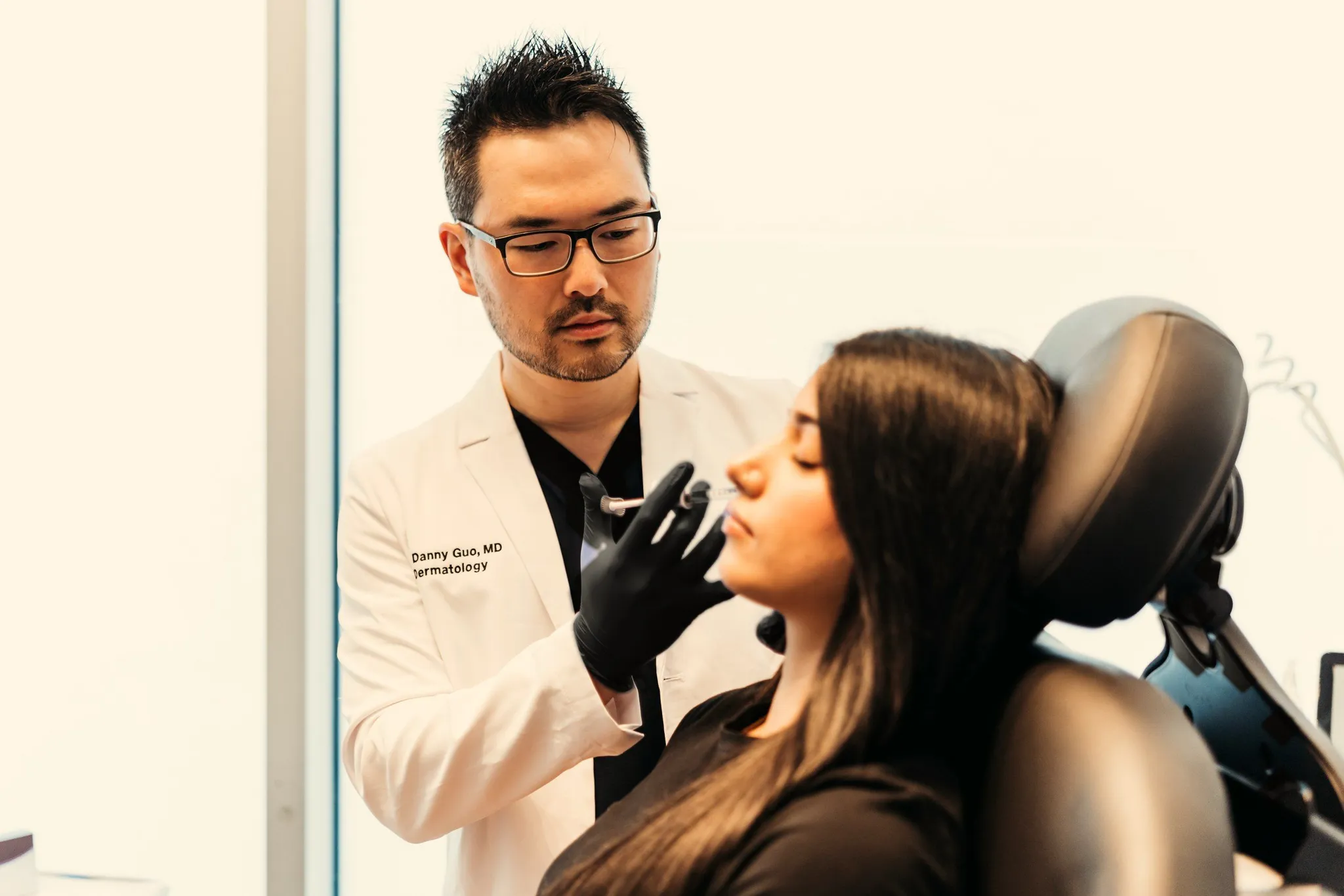 Dr. Danny Guo performing a lip filler treatment in Calgary