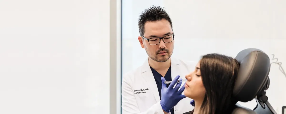 Dr. Danny Guo performing a lip filler treatment in Calgary