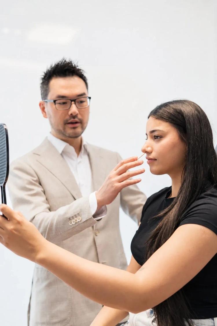 Dr. Danny Guo in consultation with a patient