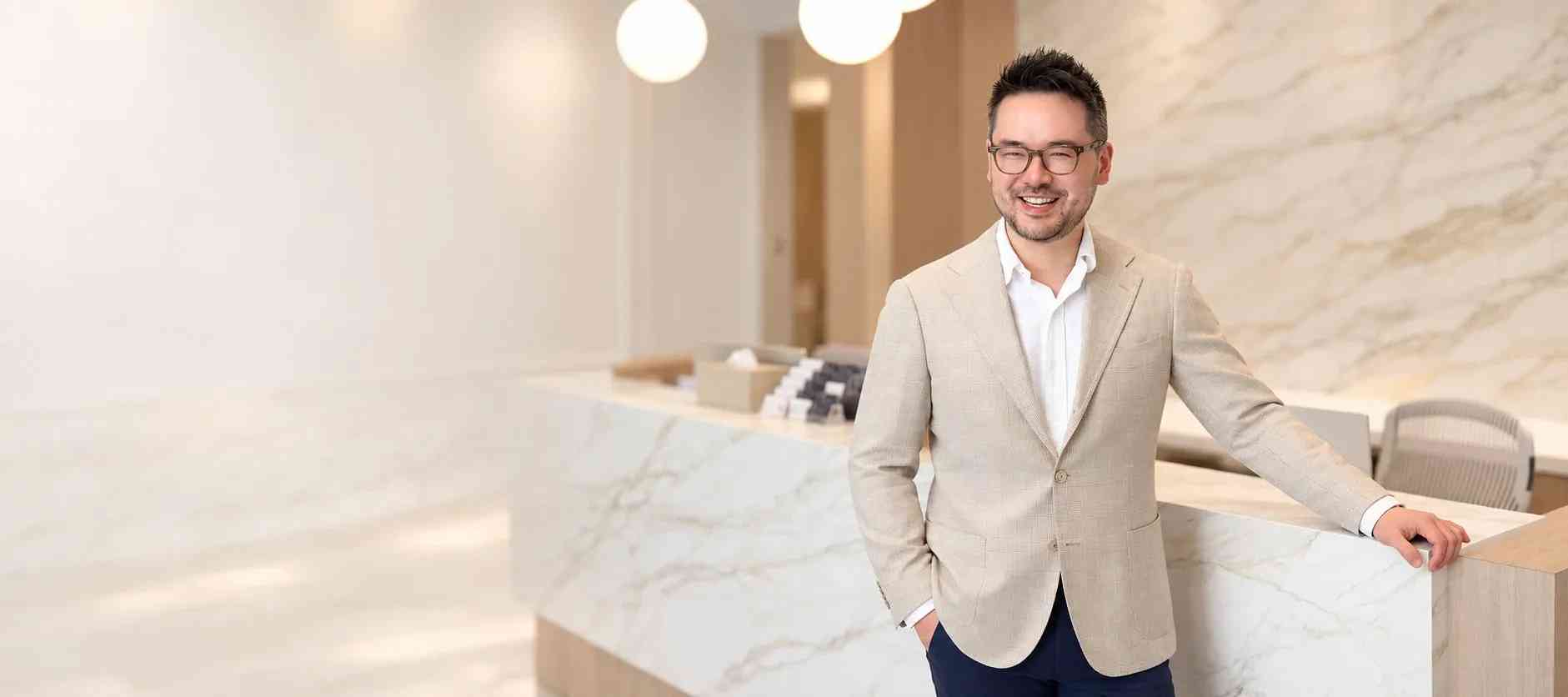 Dr. Danny Guo, cosmetic dermatologist in Calgary, at the Fountain by Rejuvenation reception
