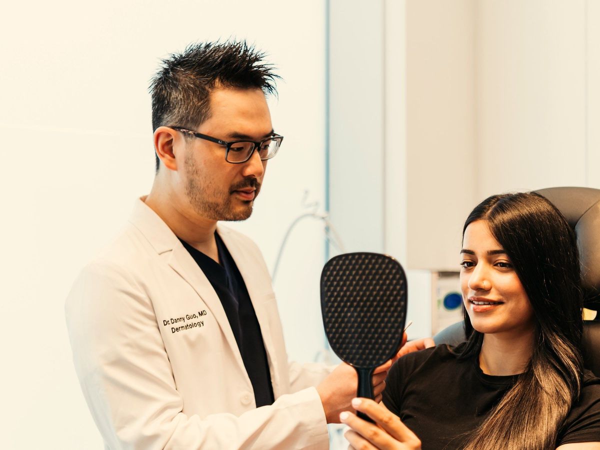 Dr. Danny Guo in consultation with a patient in Calgary