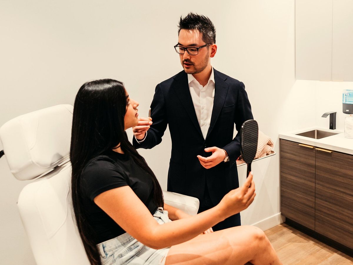 Dr. Danny Guo in consultation with a patient in Calgary